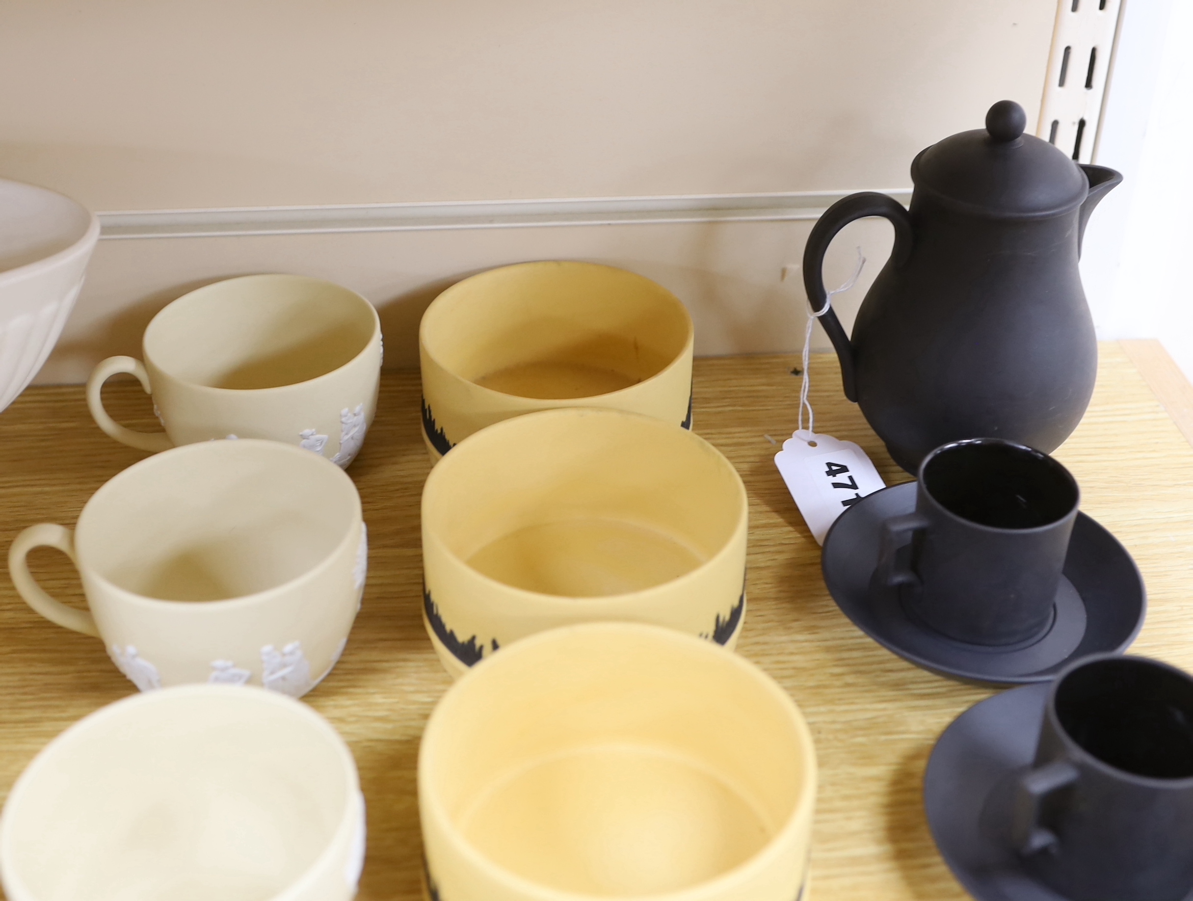 A Wedgwood black basalt coffee pot with three coffee cans and saucers, six biscuit jasper ware cups, four pots and two Etruria vases, largest vase 32cm wide, 32cm wide